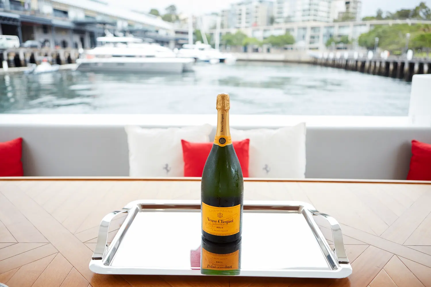 A bottle of champagne on a tray on a table.