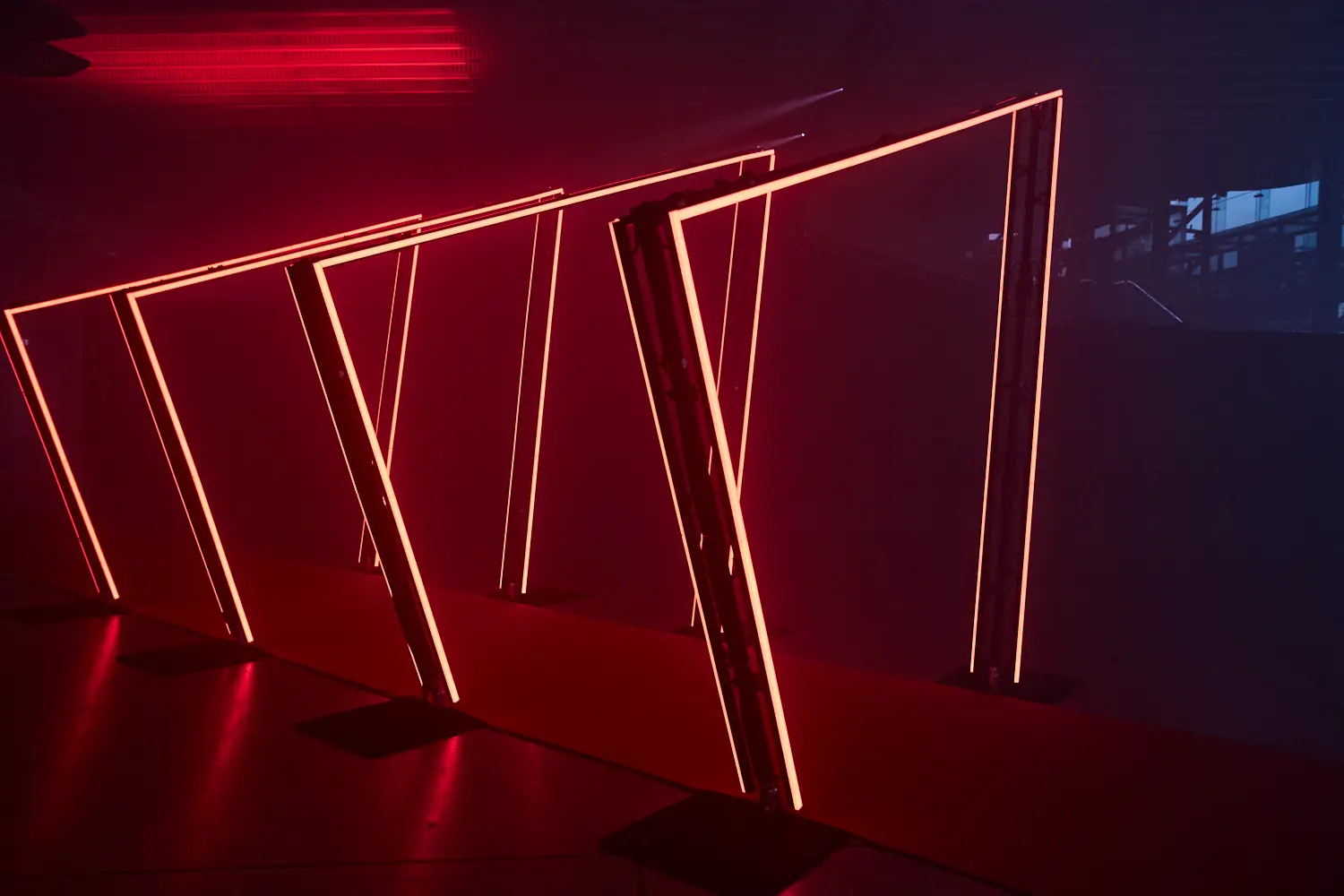 A group of red neon lights in a dark room.