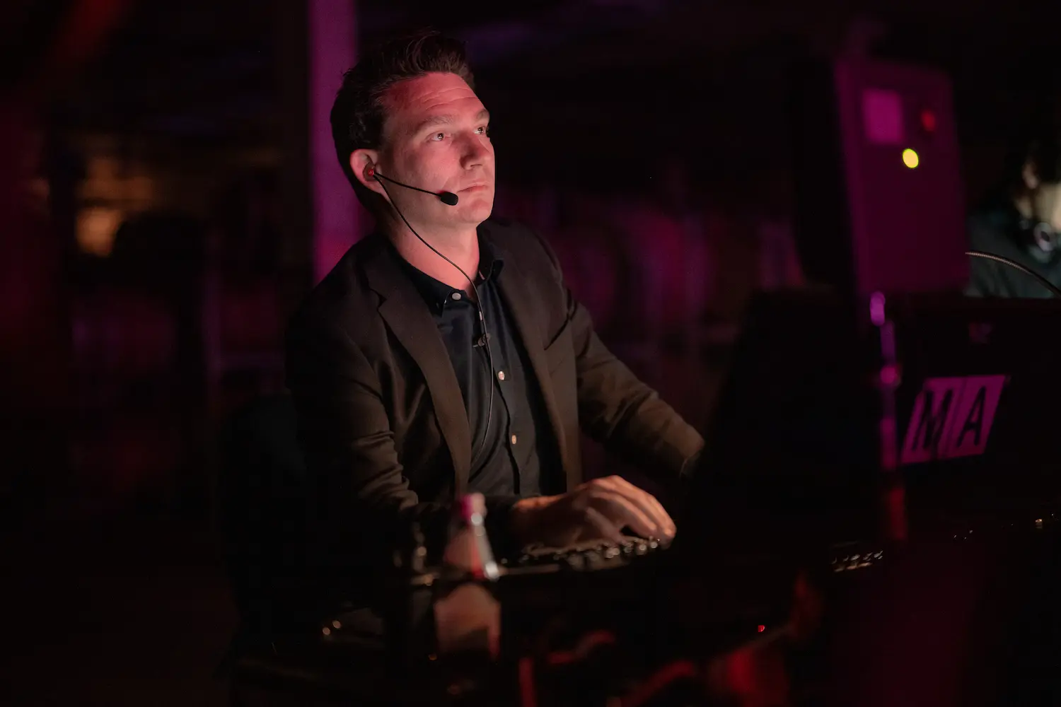 A man sitting in front of a laptop computer.