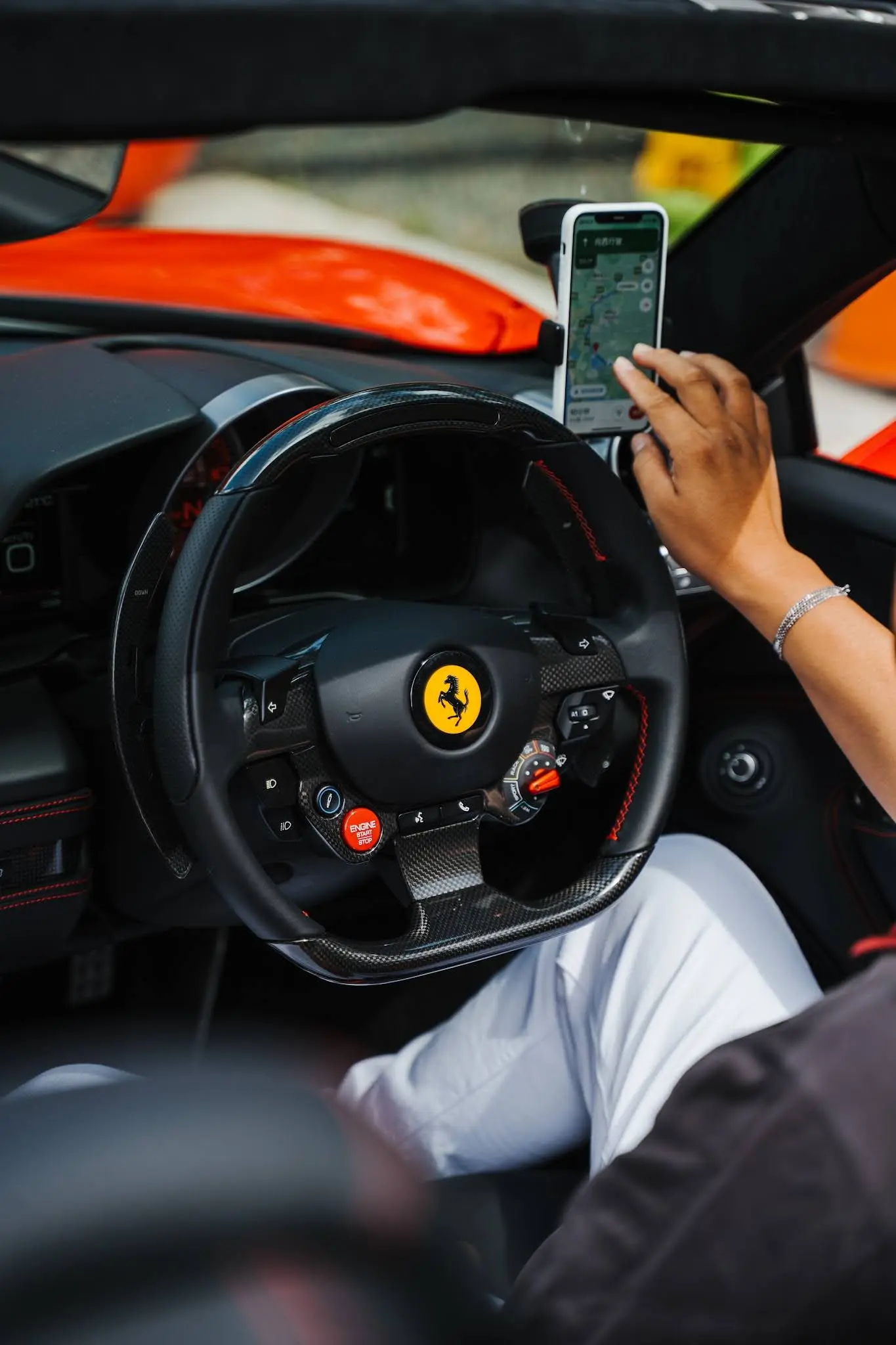 A person sitting in a car using a cell phone.
