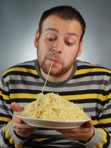 A runner eating a healthy carbohydrate meal, representing carbo loading preparation for PhysioLocal.