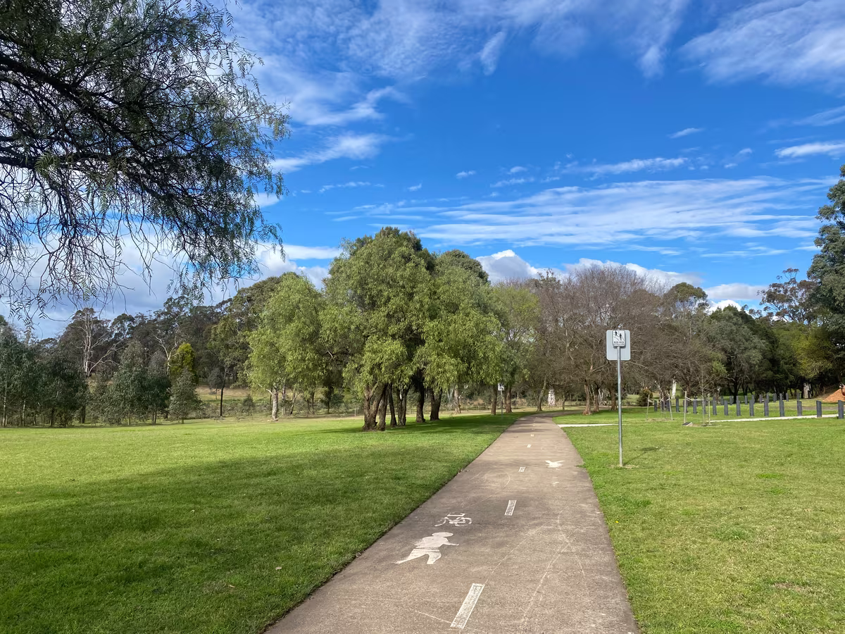 Walking path through a green park in Western Sydney