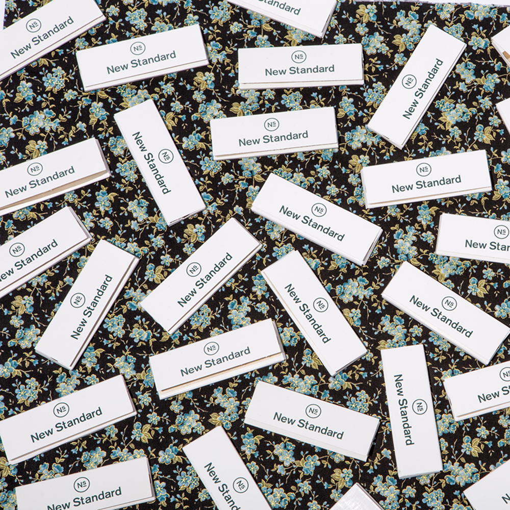 New Standard branded accessories on a floral background