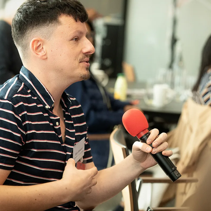 Member of the MS community speaking into a microphone