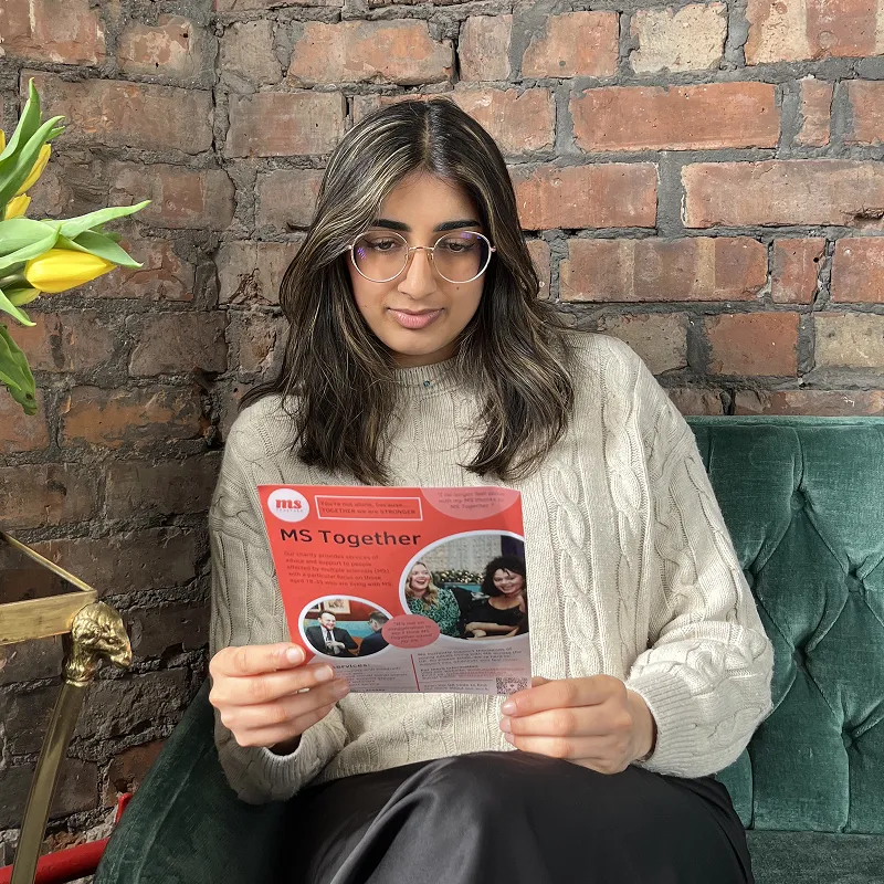 Person with MS learning more from an MS Together leaflet