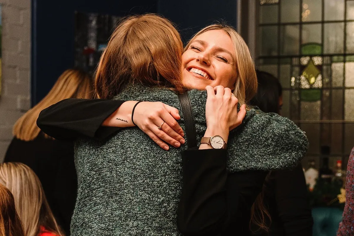 Amy and a member from MS Together hugging
