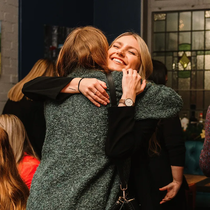 Amy CEO hugging another person