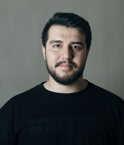 Portrait of Mohammad M Khani, wearing a black t-shirt against a neutral grey background.