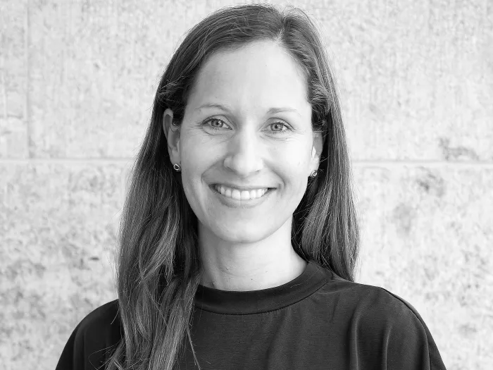 Black and white portrait of Anna Buchmann, smiling.