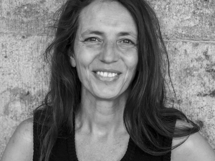 Black and white portrait of Anne Range, smiling.