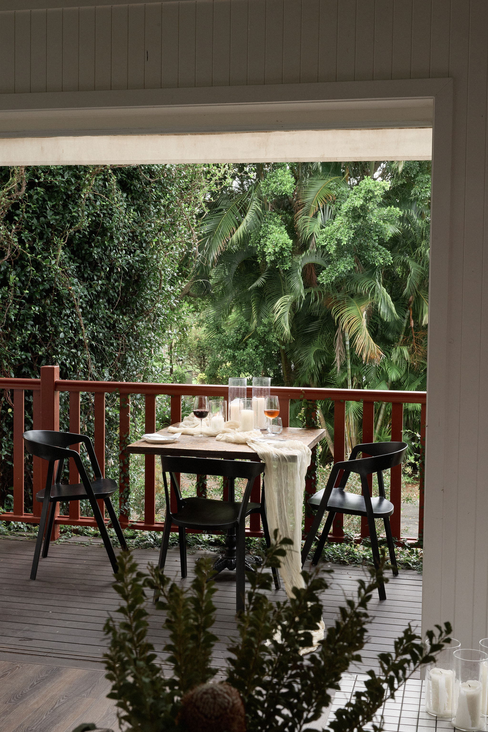 Intimate deck table set for dinner with valley views at Greenhouse Canteen