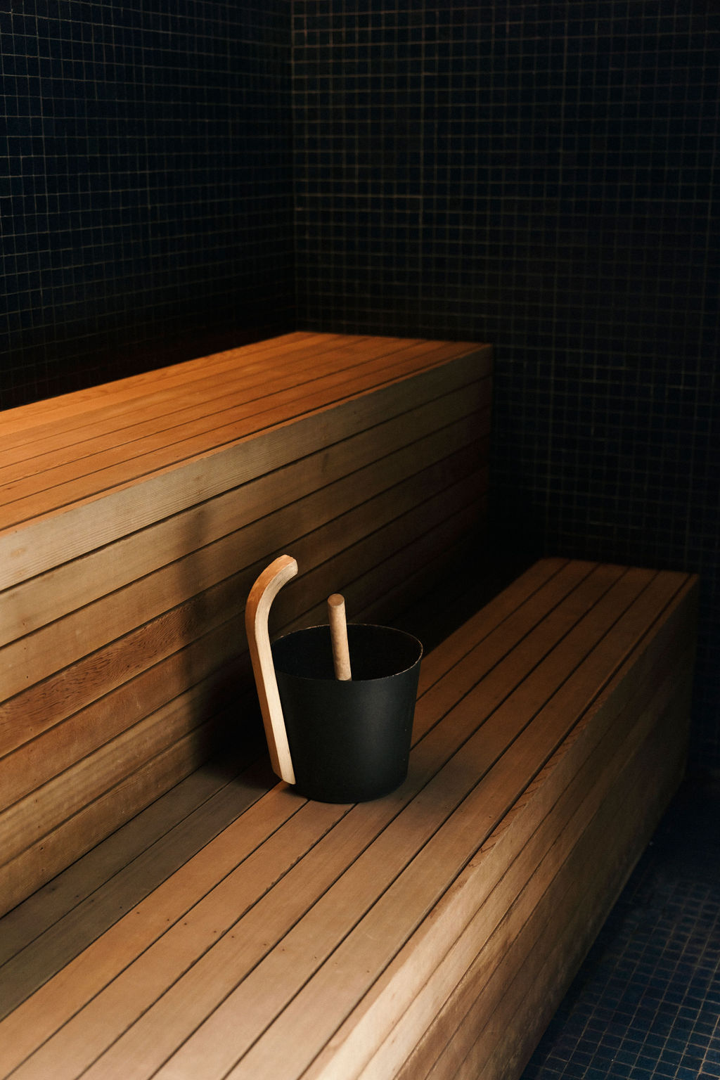 Red cedar sauna with traditional wooden bucket and ladle at Greenhouse