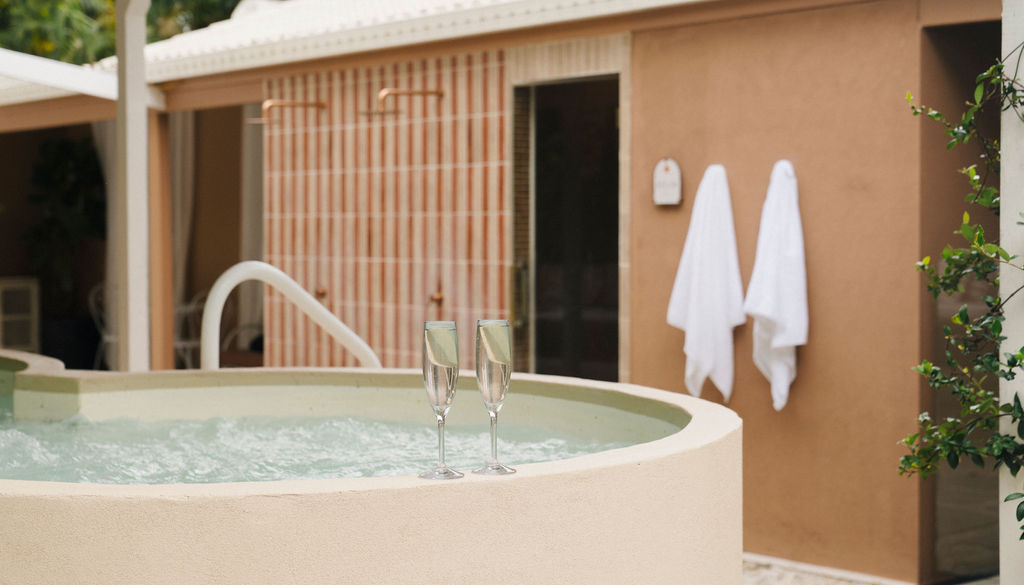 Spa pool with champagne glasses at Greenhouse Bathhouse