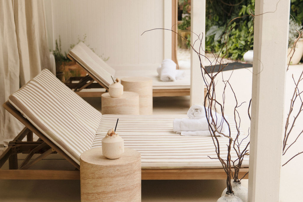 Striped loungers and towels in the bathhouse cabana at Greenhouse