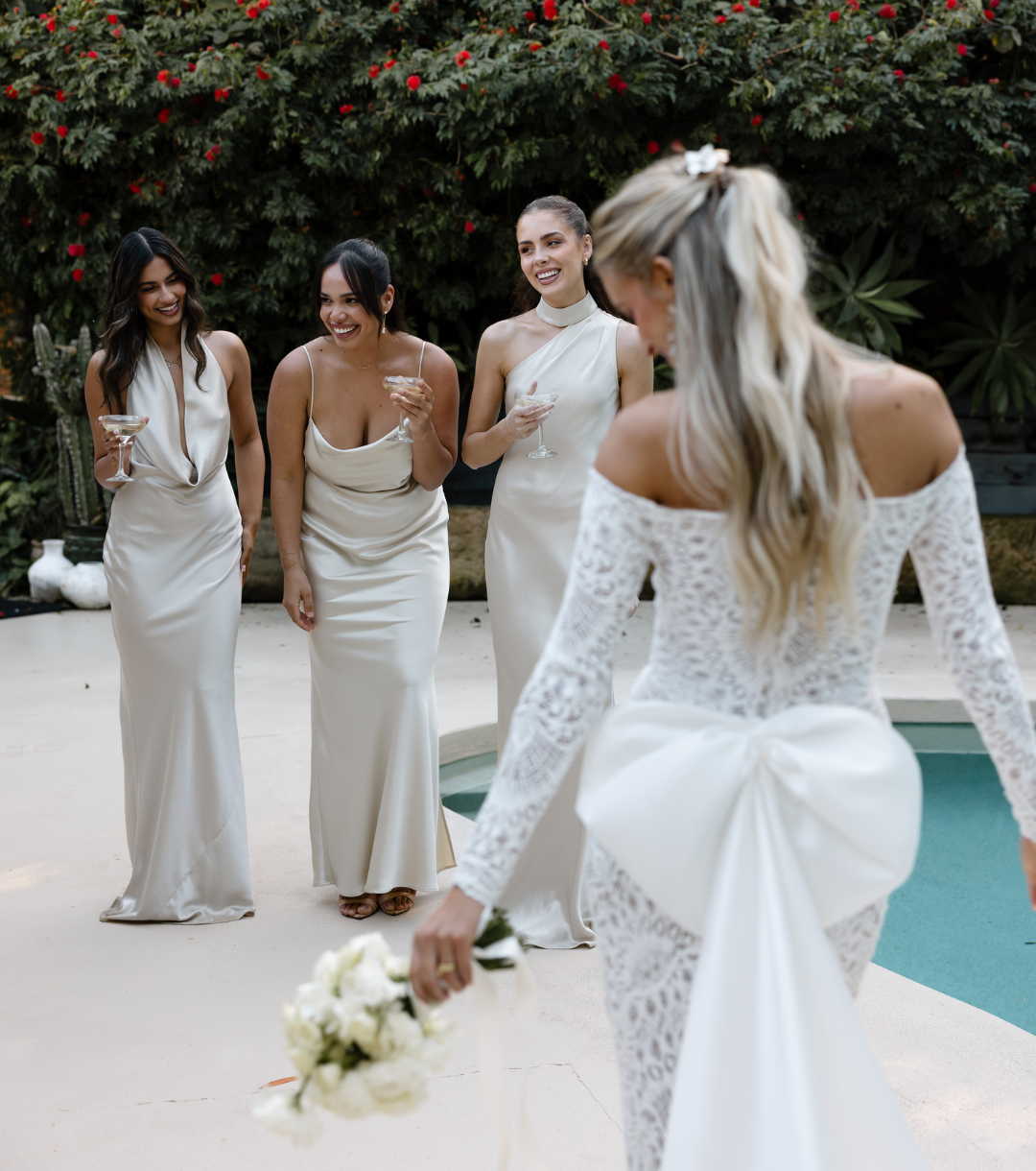 Bride with bridesmaids in champagne satin laughing poolside at 268 Estate, Tallebudgera Valley