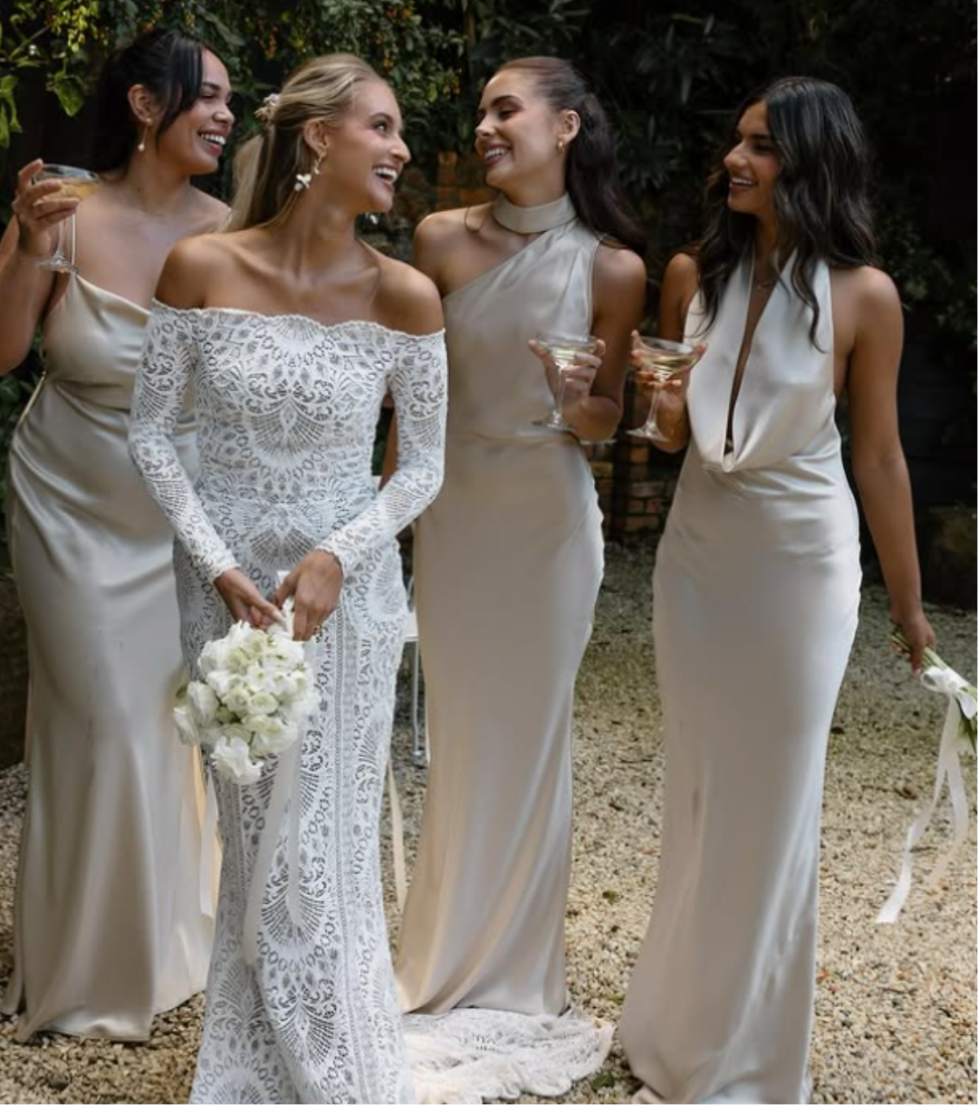 Bride in lace long-sleeve gown with bridal party in champagne satin laughing outdoors at 268 Estate