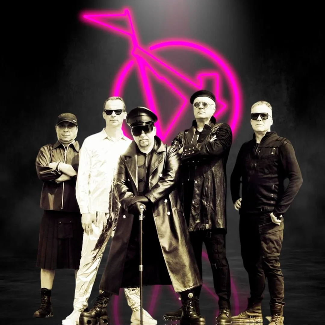 Five men wearing dark and white outfits posing with a neon pink circle and arrow symbol behind them.