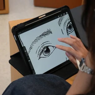 Student drawing on an iPad during a digital art class