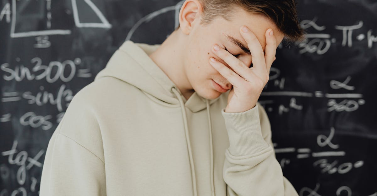 Adulto em ambiente de trabalho com expressão pensativa rodeado de notas e tarefas por concluir, representando os sintomas invisíveis da PHDA no adulto