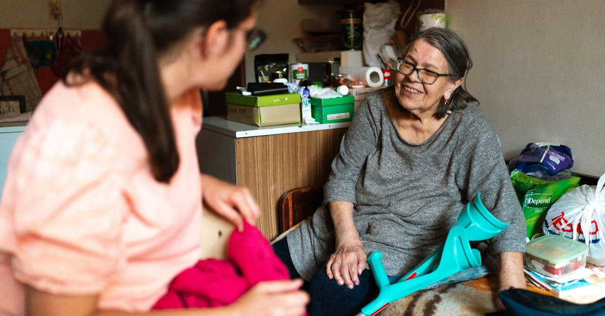 Cuidadora familiar de mãos dadas com pessoa idosa com doença de Alzheimer numa sala luminosa de uma casa em Portugal