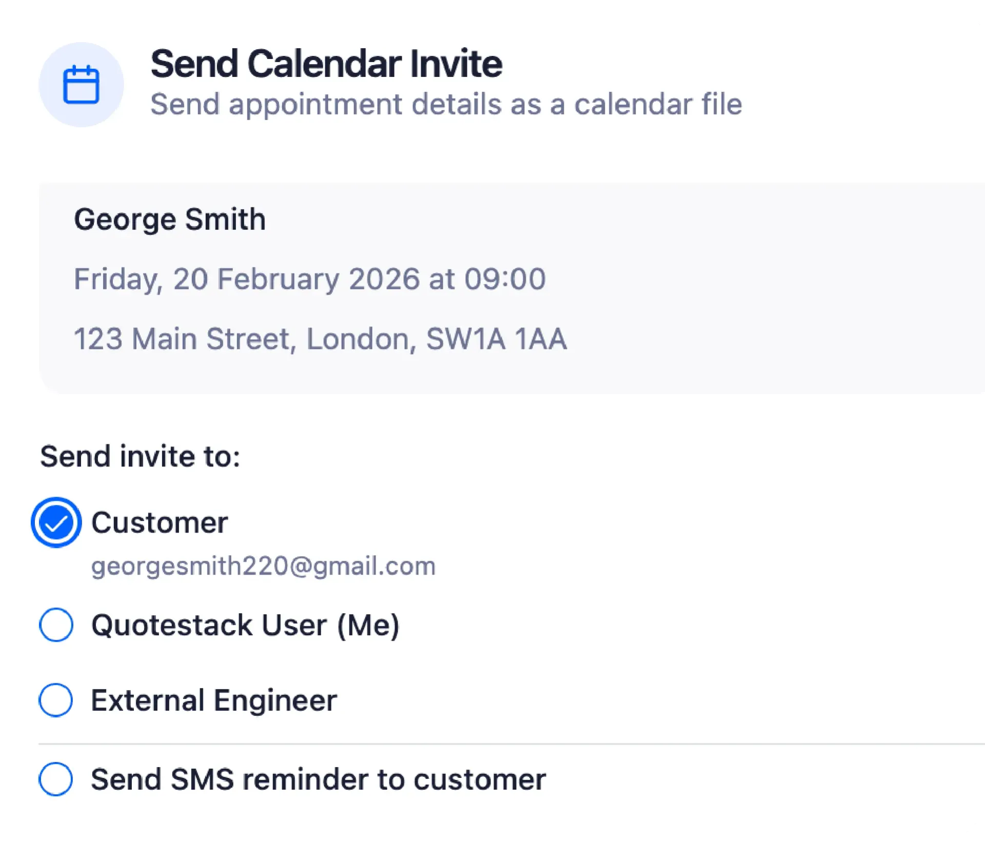 Open laptop next to a stack of books and an open book on a wooden table in a library.