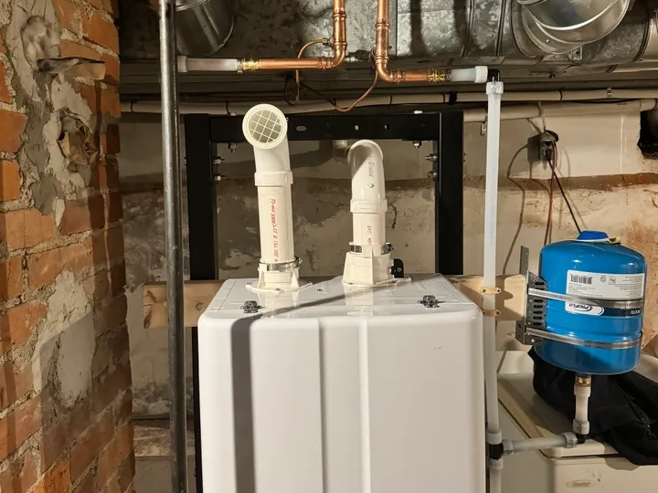 a tankless water heater being installed in a basement