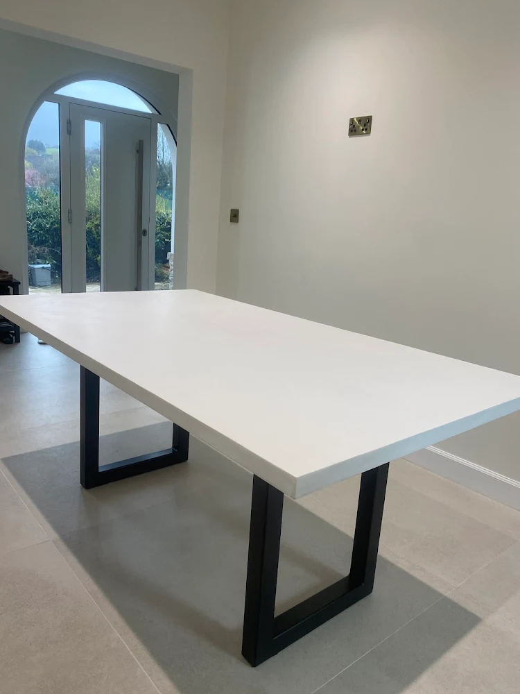 White slimline polished concrete dining table with textured surface by RockVine