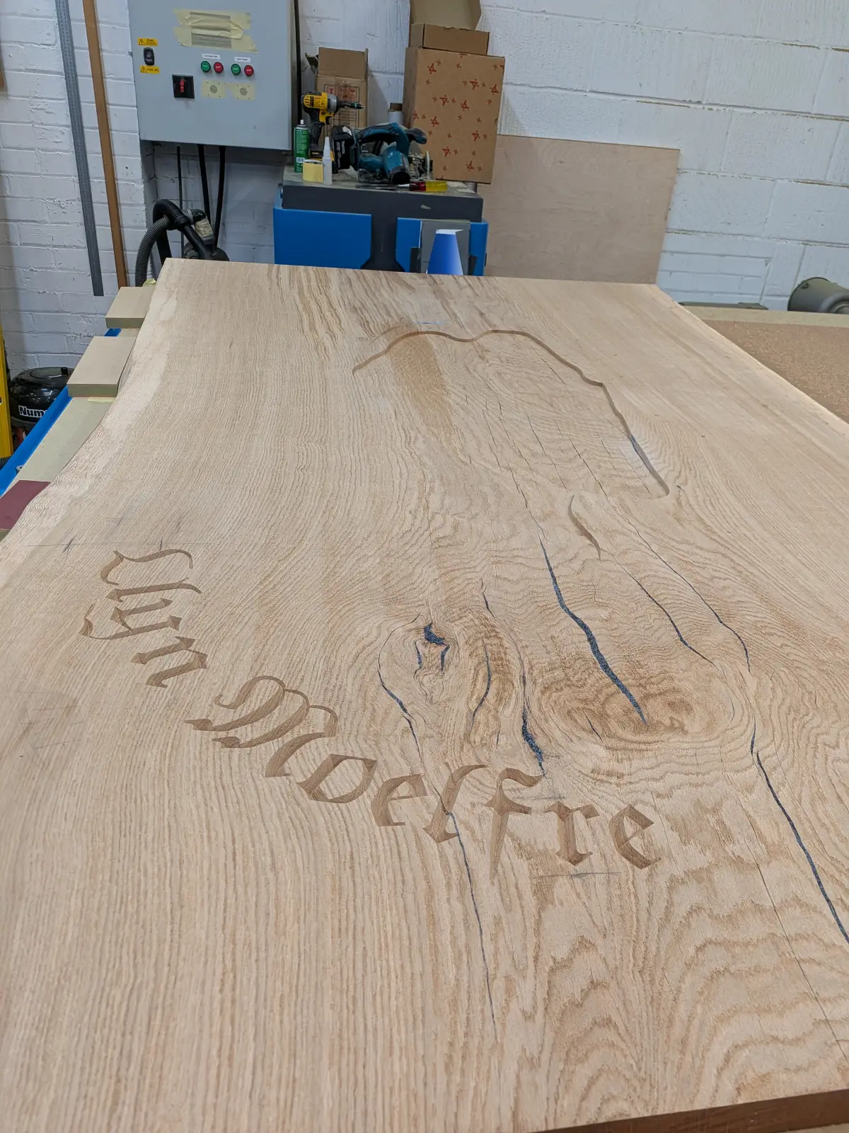 Resin river table with lake design and lettering ready to be poured by RockVine