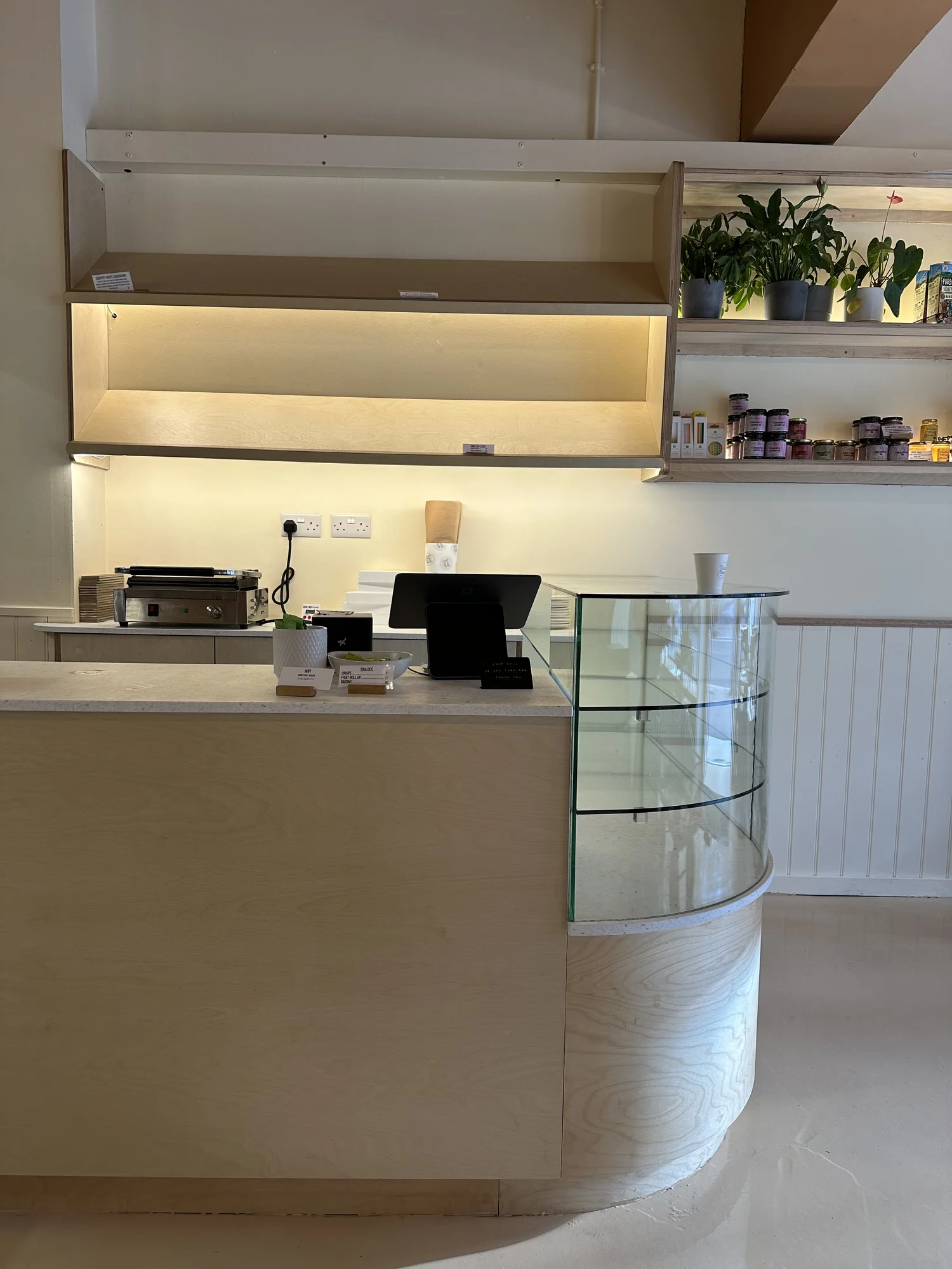 Curved commercial counter in timber and glass