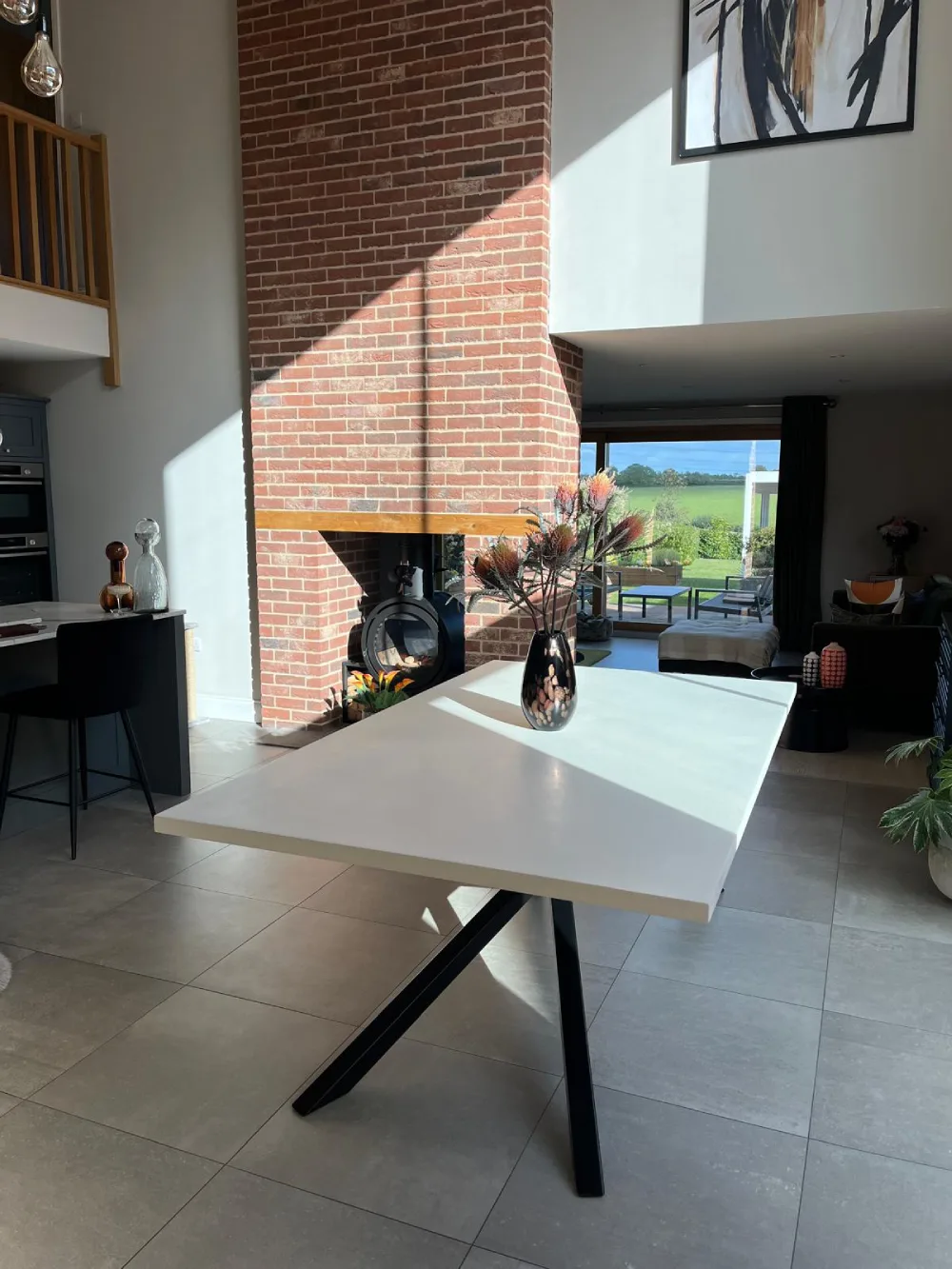 Hand-finished white polished concrete dining table on butterfly base