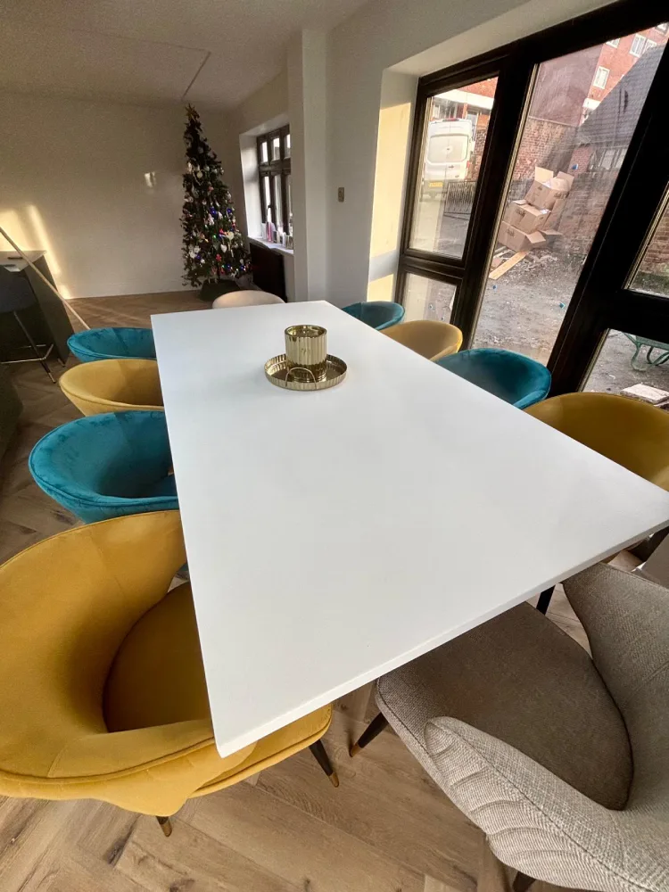 Slimline white polished concrete dining table with statement chairs in Leeds
