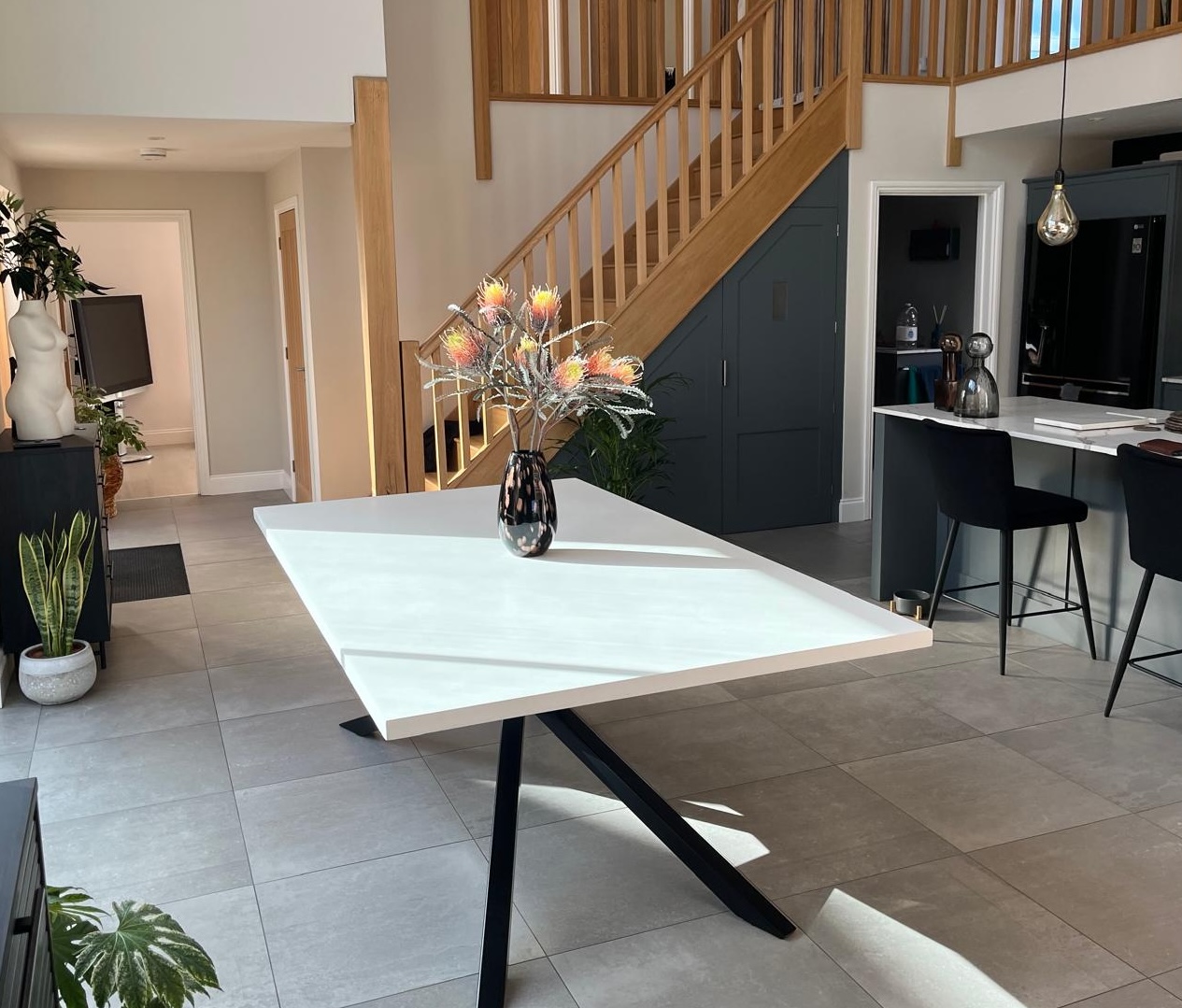 Pristine white polished concrete dining table on a butterfly base by RockVine