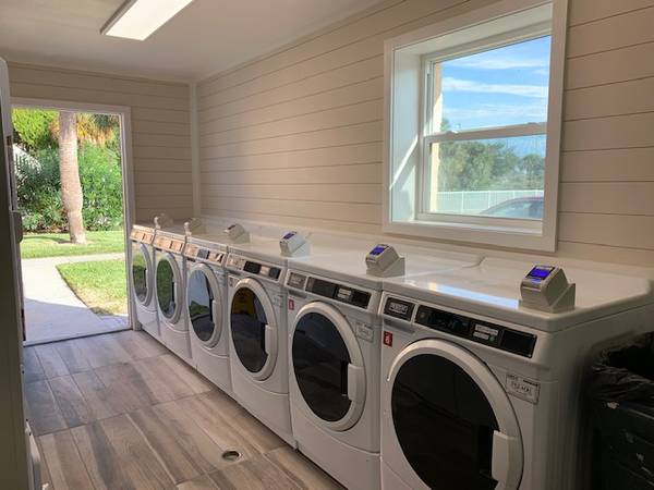 Laundry facilities with white appliances