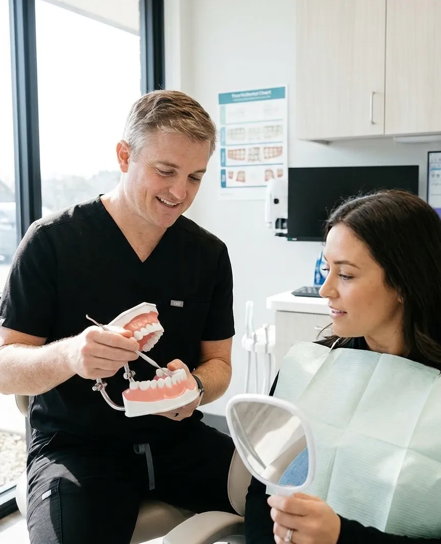 A Dentist talking to one of his patients