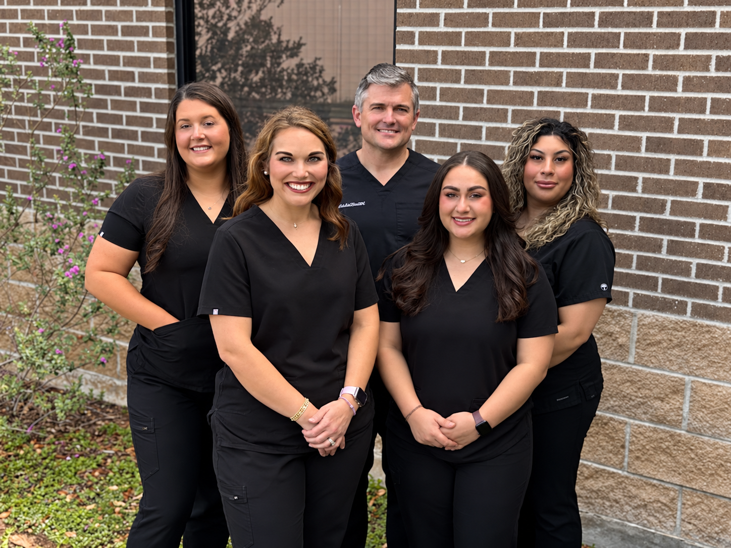 Dr. Taylor Schaar and the Schaar Dental Wellness team smiling outside the Victoria, TX dental office
