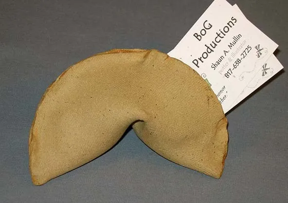 Under gold foil lays a surprise business card like and fortunate cookies.