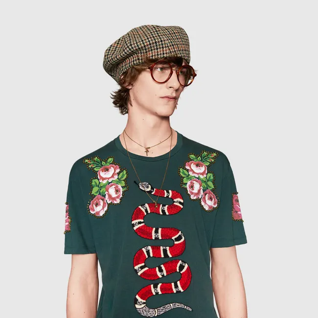 Gucci expensive clothing brand from Italy, offering stylish tees and accessories with iconic logo, chic creativity and glamorous fashion style.