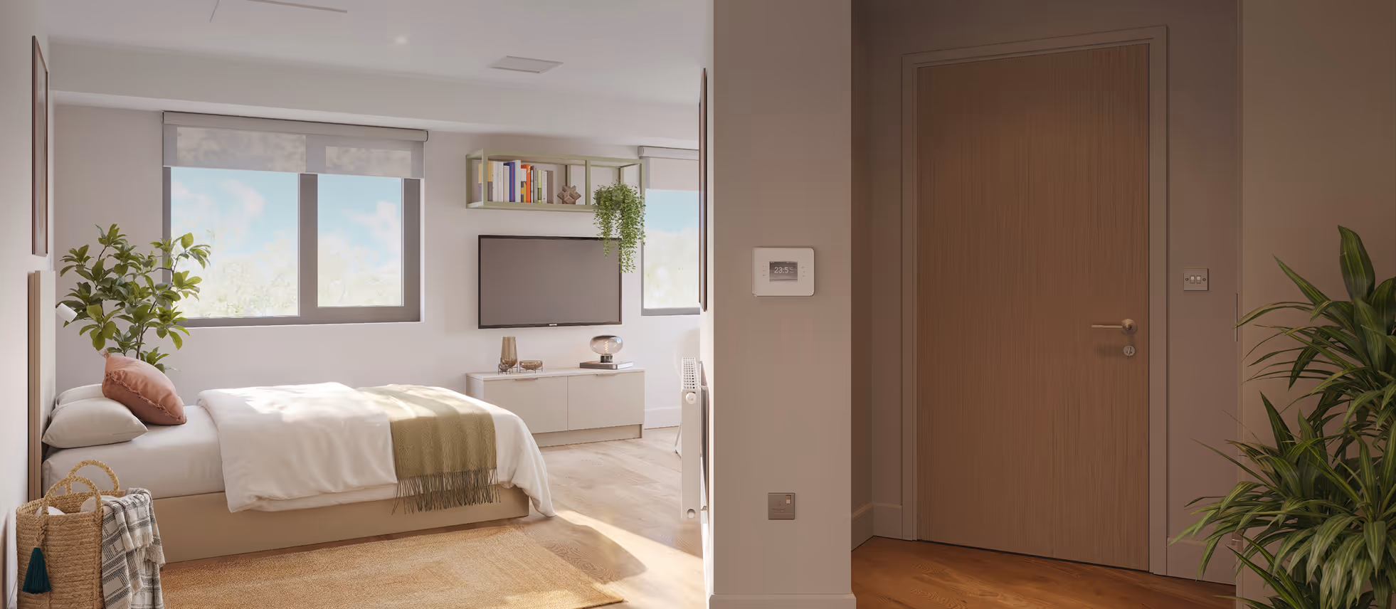 Bright bedroom with a bed, green throw blanket, pillow, indoor plants, wall-mounted TV, and wooden door in entryway.