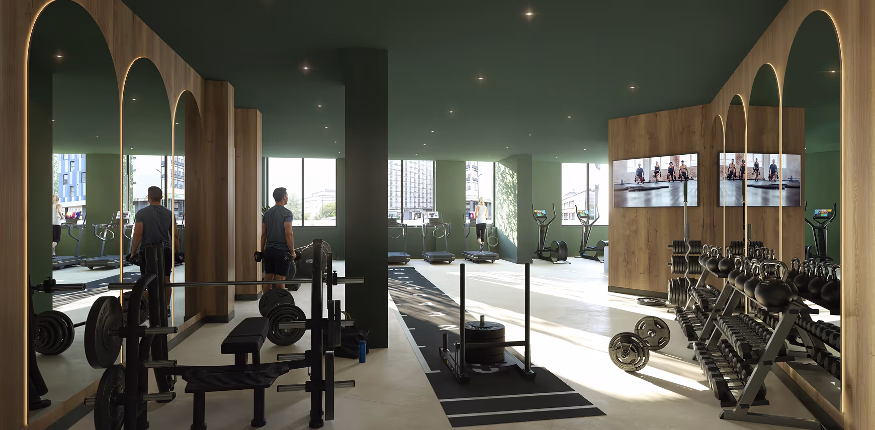 Modern gym with weightlifting bench, dumbbells, kettlebells, sled push equipment, and treadmills by large windows with natural light.