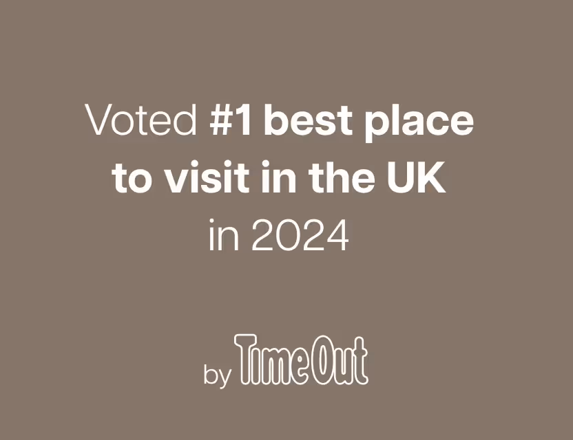 Text stating 'Voted #1 best place to visit in the UK in 2024 by Time Out' on a taupe background.