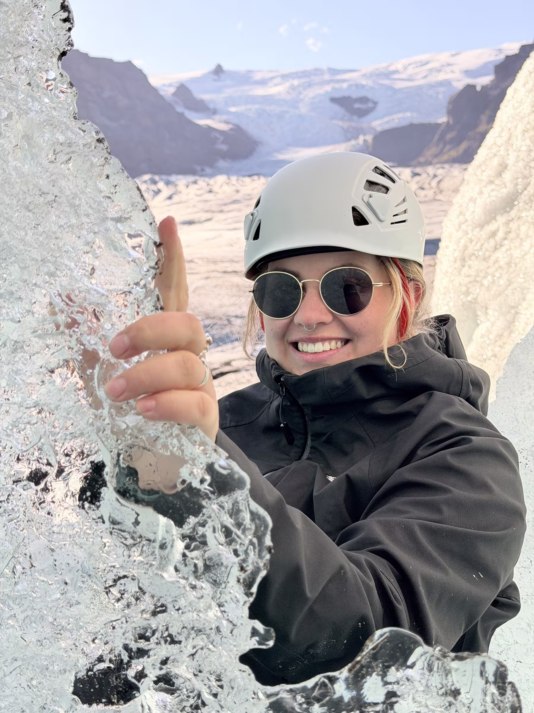 Hiker in helmet, sunglasses and layered clothing on an Iceland glacier hike