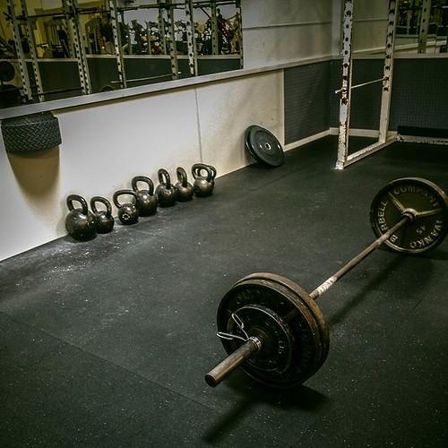 Barbell weightlifting setup in a gym, representative of CrossFit Commence in Fayetteville, Arkansas