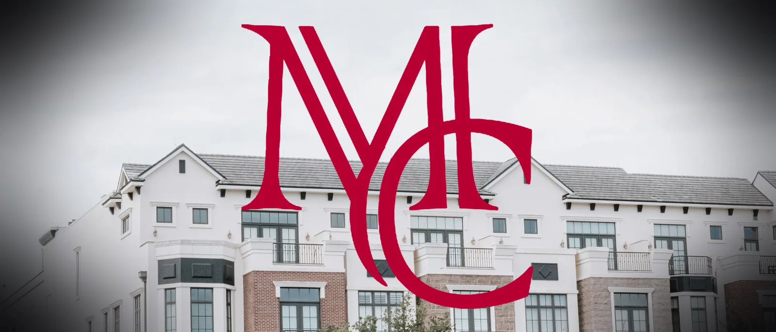 Exterior of a multifamily apartment building with balconies — MCG