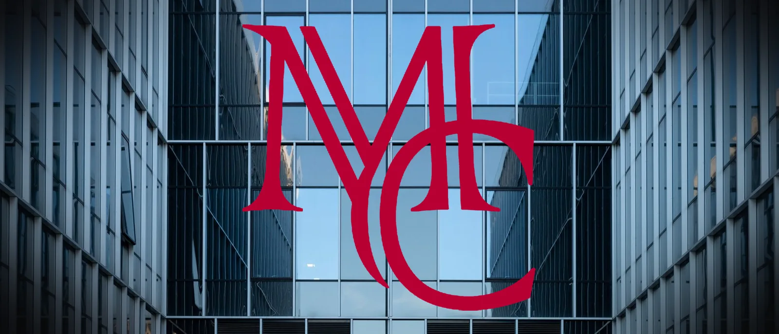 Glass and steel commercial office building facade viewed from below — MCG