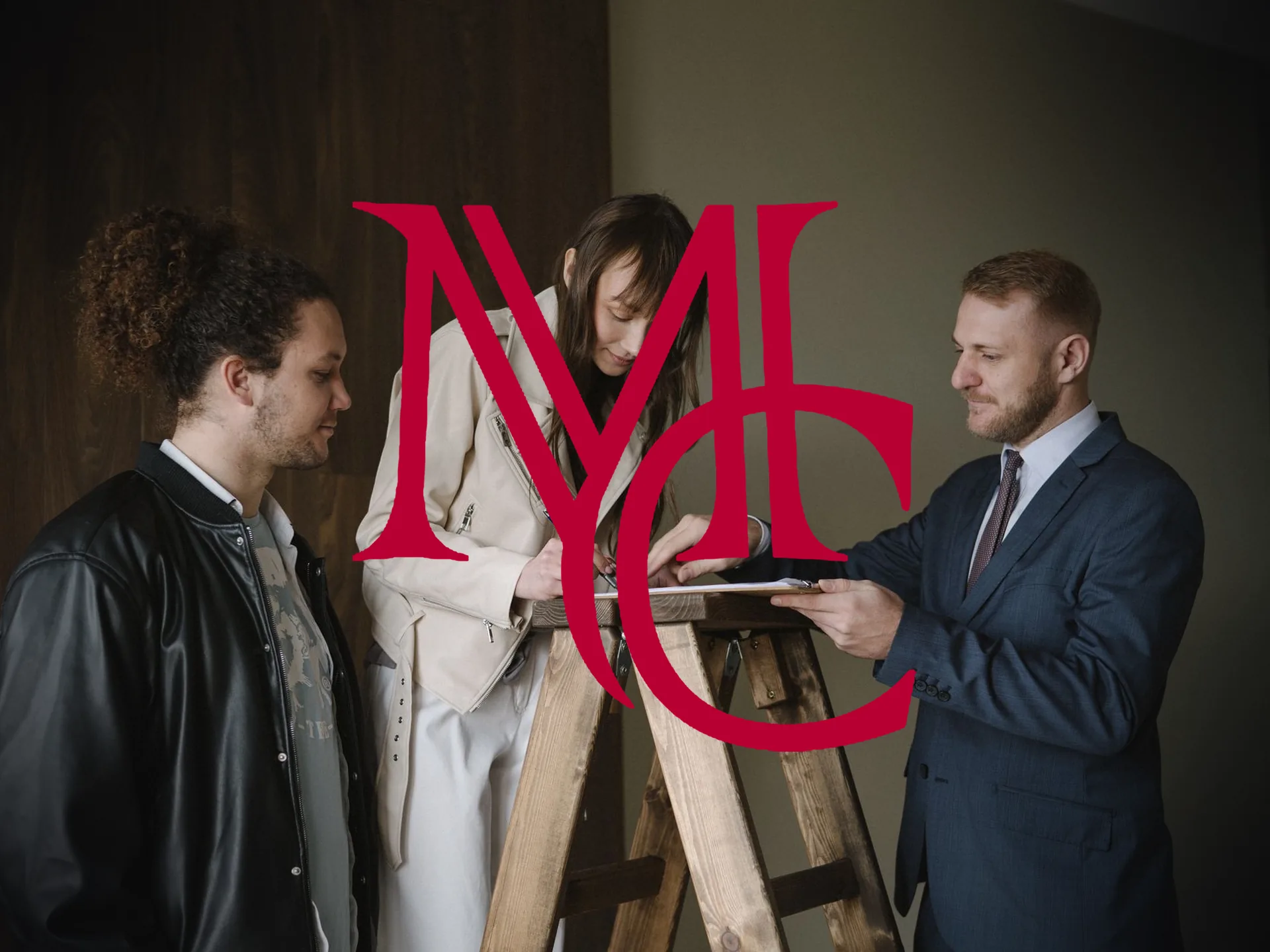 A real estate agent presenting a document for a couple to sign inside a home — MCG