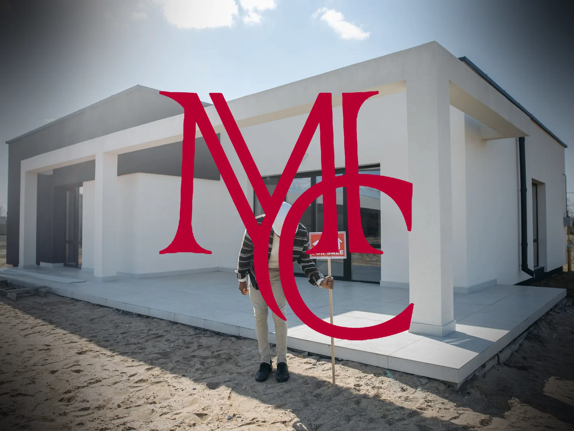A person holding a for-sale sign in front of a newly built single-story property — MCG