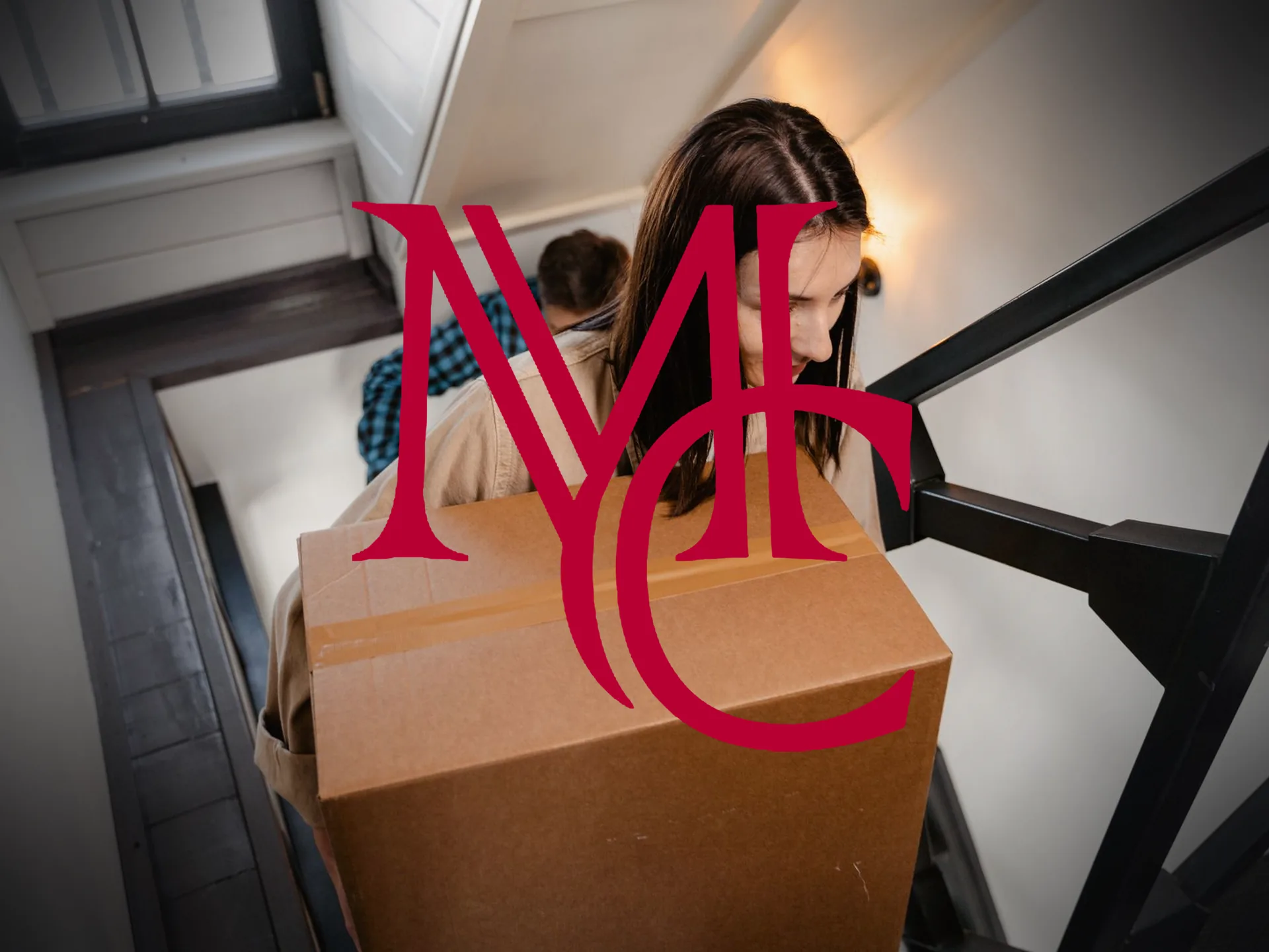 A couple carries moving boxes up the stairs into their new home — MCG