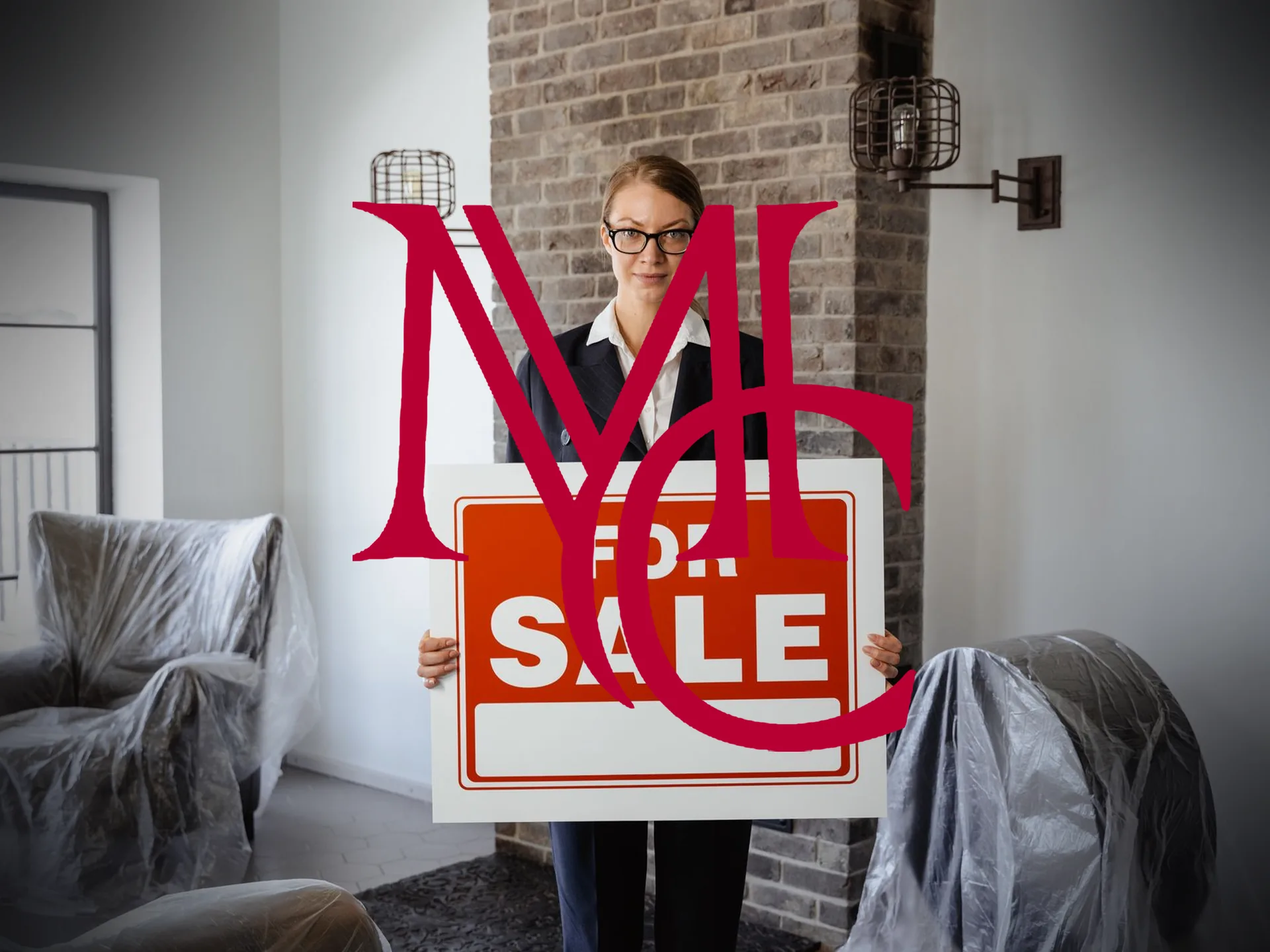 A real estate agent in a blazer holding a For Sale sign in a room with furniture under plastic covers — MCG