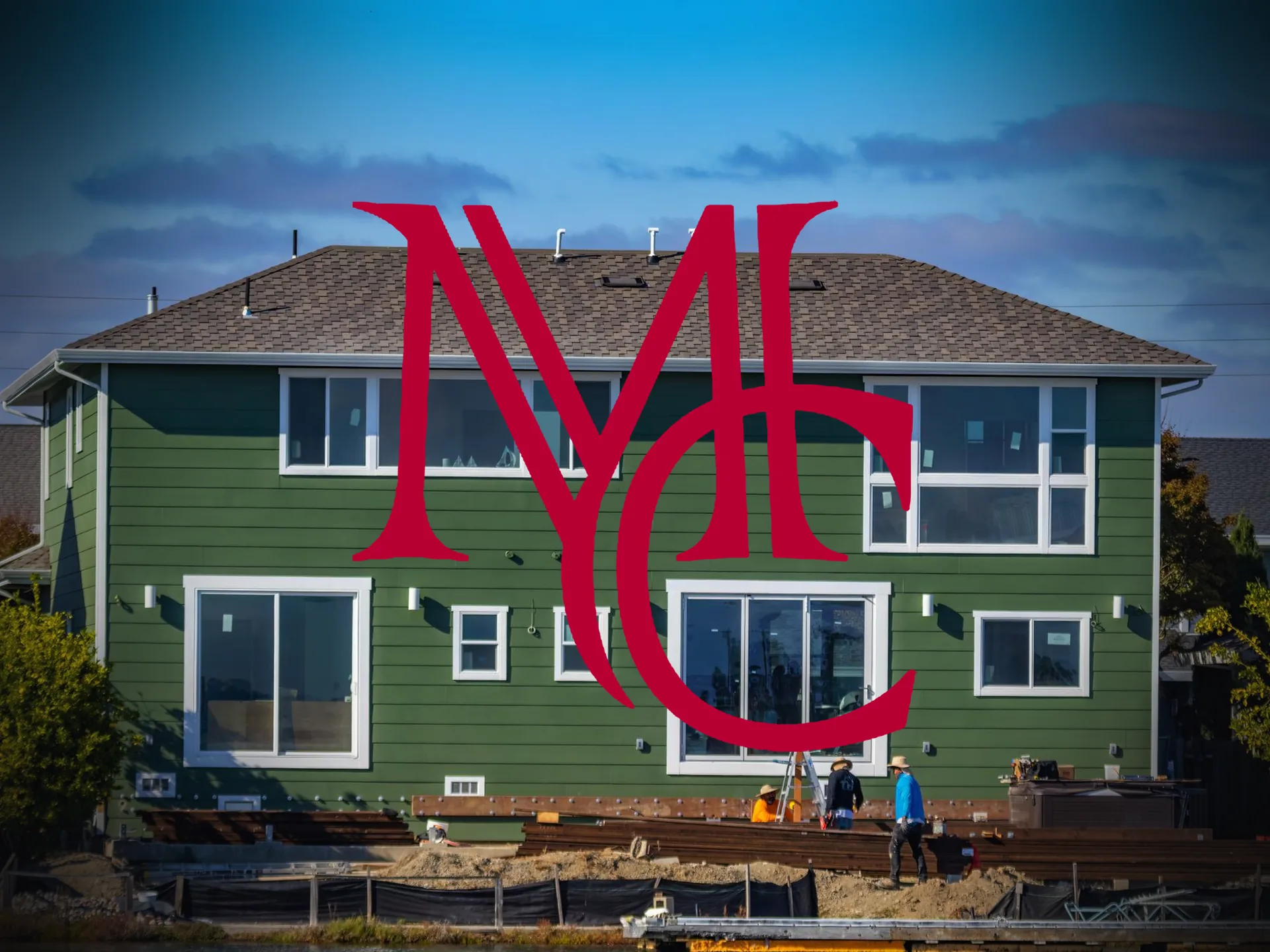 Construction workers on site at a two-story home under construction — MCG