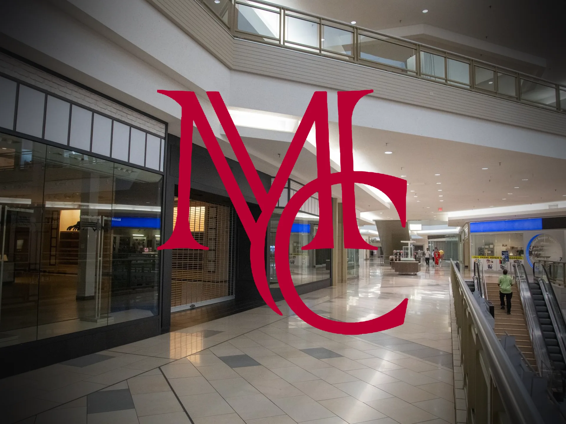 A shuttered storefront along an empty shopping mall concourse — MCG